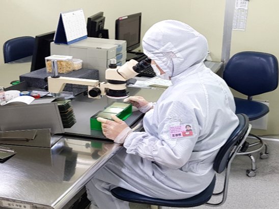 Nhân viên kiểm tra bảng mạch tại IB Tech